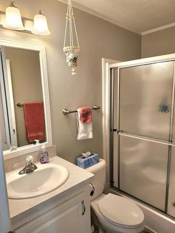 a bathroom with a shower and toilet