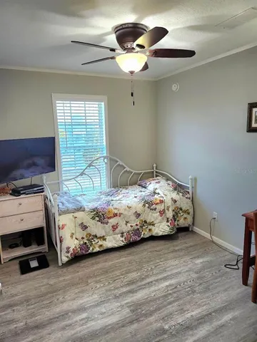 a bedroom with a bed and a lamp on dresser