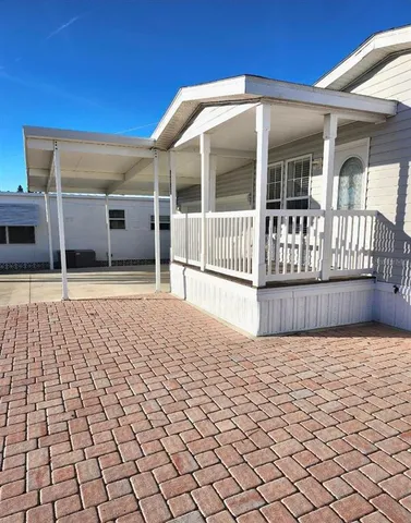 a view of a house with wooden fence