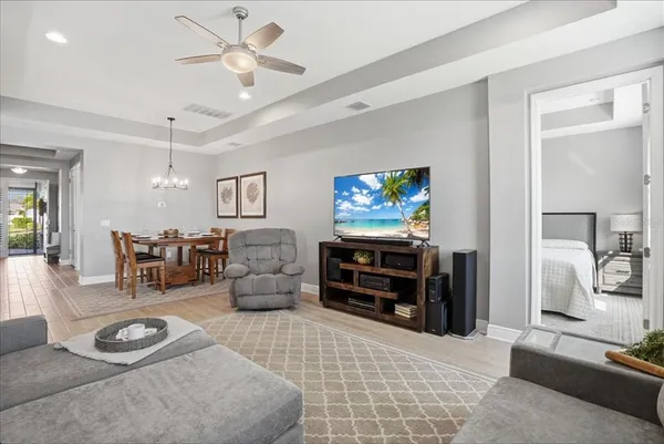a view of a kitchen with stainless steel appliances granite countertop a sink dishwasher a stove top oven a clock and cabinets