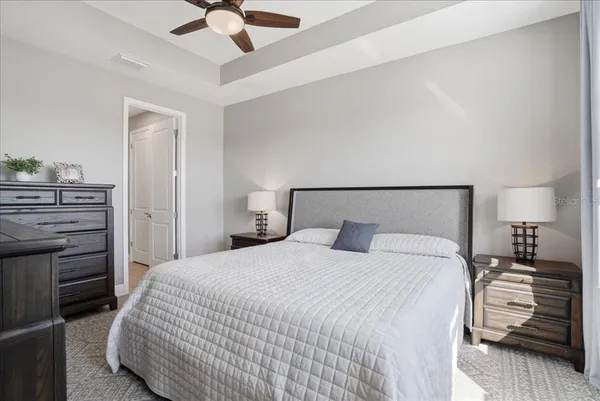 a en suite bathroom with a granite countertop shower and a mirror