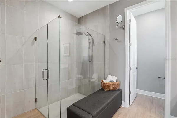 a bedroom with a large bed and a chandelier