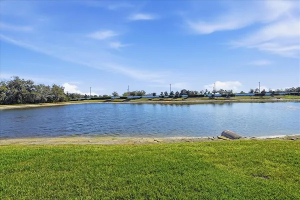 an aerial view of a house with a garden and lake view