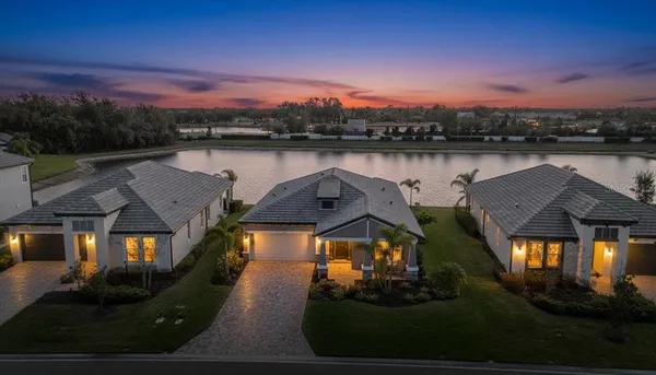 an aerial view of a house with a yard lake view and mountain view