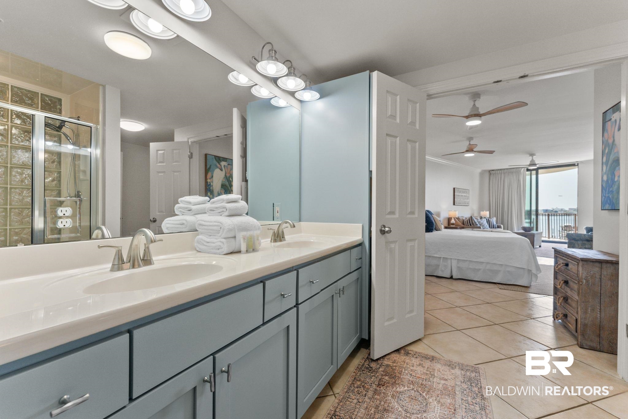 27580 Canal Road, Unit 1233 Orange Beach, AL 36561 - Photo 22 of 79 Full bath featuring double vanity, ensuite bathroom, ceiling fan, light tile patterned flooring, and a stall shower
