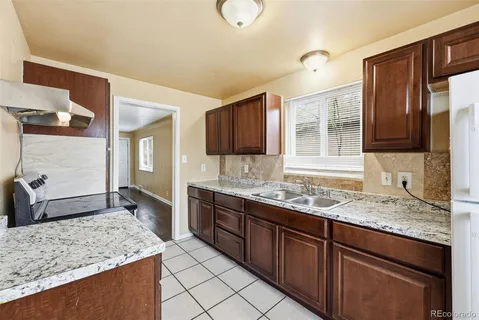 a kitchen with stainless steel appliances granite countertop a sink stove and cabinets