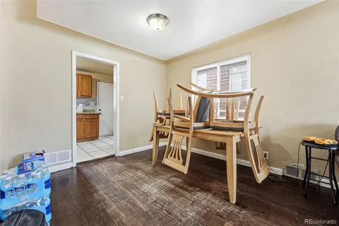 a workspace room with wooden floor lounge chair and windows