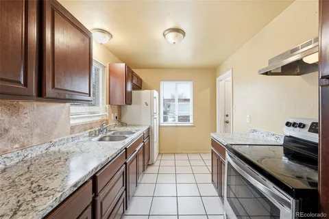 a kitchen with stainless steel appliances granite countertop a sink stove and cabinets