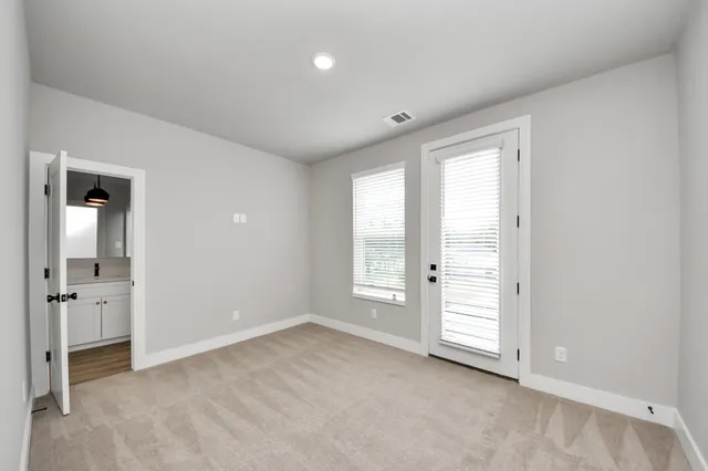 an empty room with windows and closet