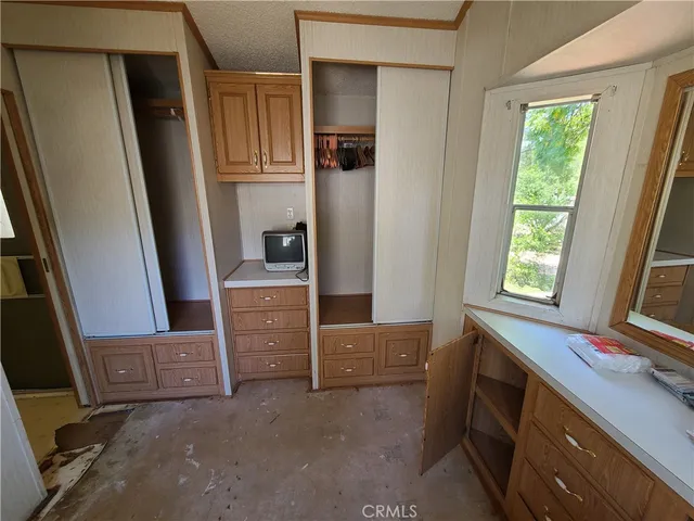 a view of room with window and cabinet