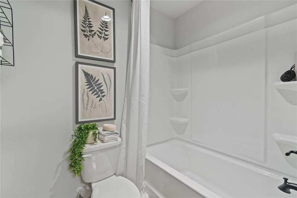 27 Cardinal Rdg Court Winder, GA 30680 - Photo 16 of 71 a bathroom with a toilet and a shower