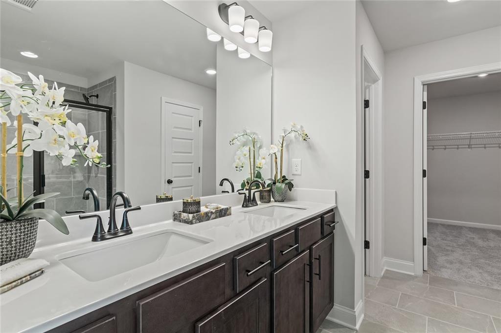 27 Cardinal Rdg Court Winder, GA 30680 - Photo 25 of 71 a bathroom with a sink double vanity and a mirror