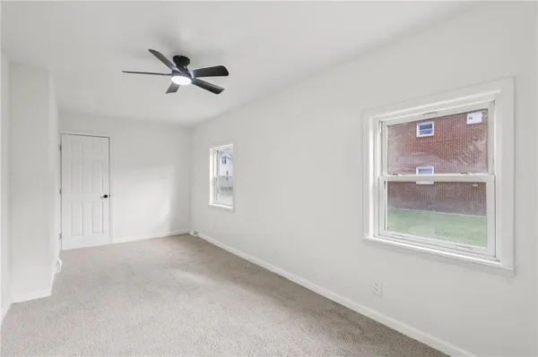 a view of room with a ceiling fan and window