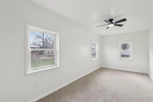 a view of room with a ceiling fan and a window
