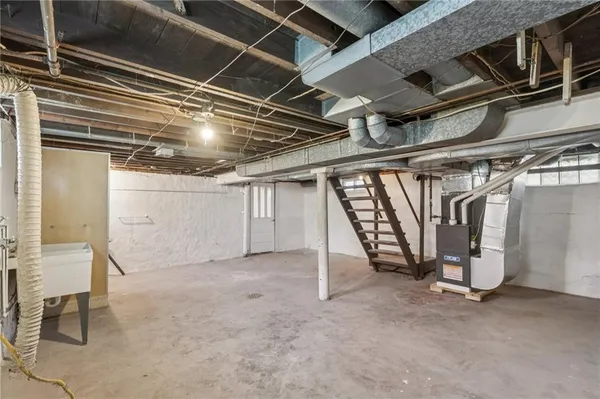 a view of water heater room with stairs