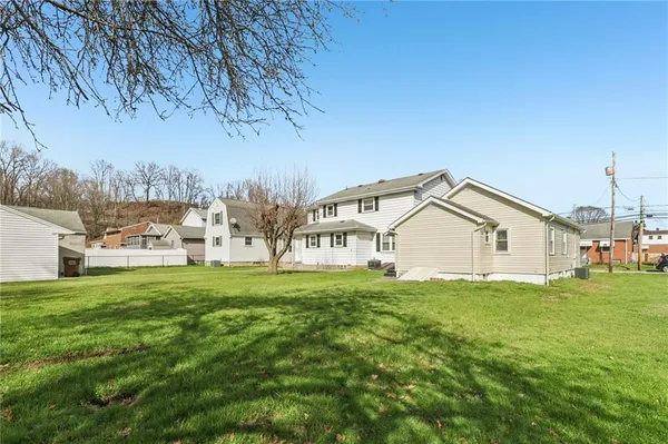 a house with huge green field in front of it