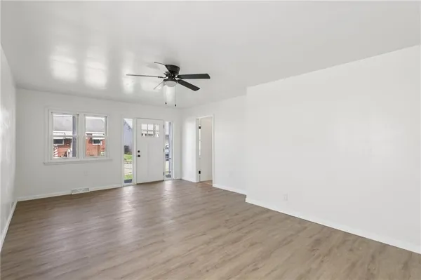 wooden floor in an empty room with a window