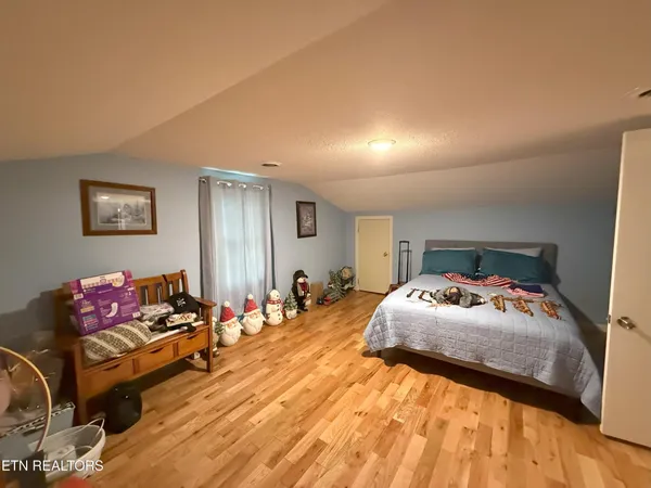 a bedroom with a bed and a couch