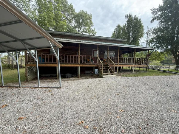a view of house with backyard space and seating area