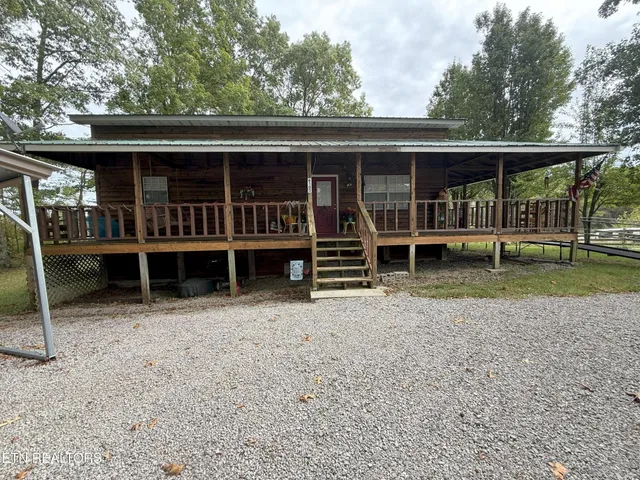 an outdoor view of house with backyard space and balcony