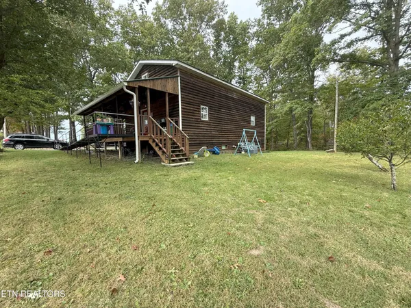 a view of a wooden house with a yard