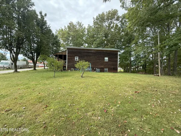 a view of outdoor space with deck and yard