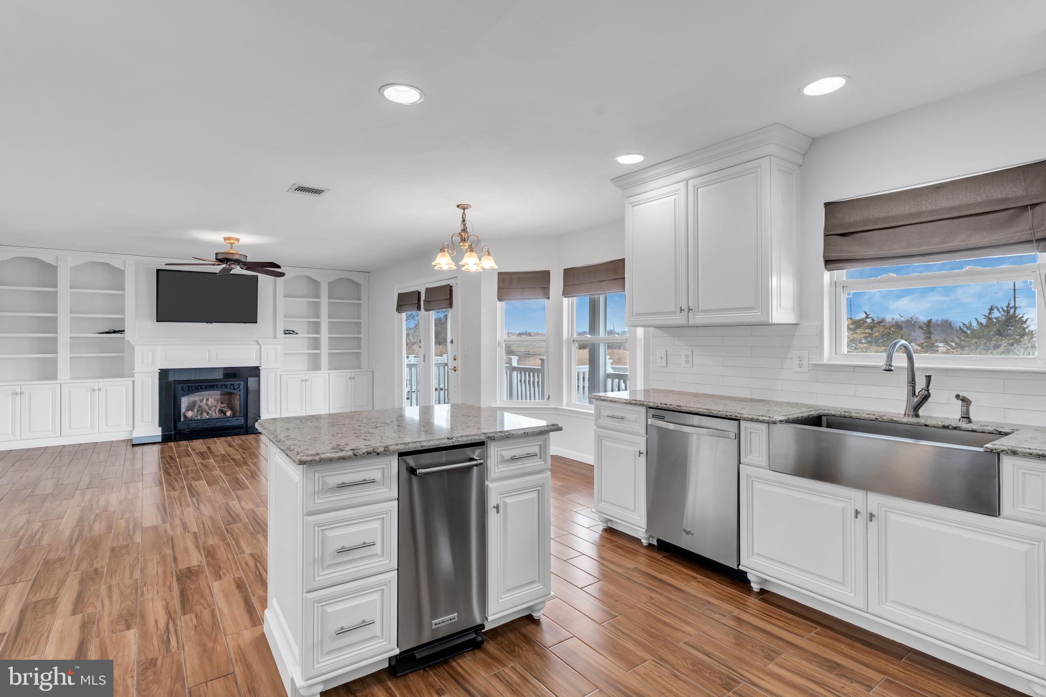 68 Morris Boulevard Manahawkin, NJ 08050 - Photo 12 of 43 a kitchen with stainless steel appliances granite countertop a sink a stove and a wooden floors