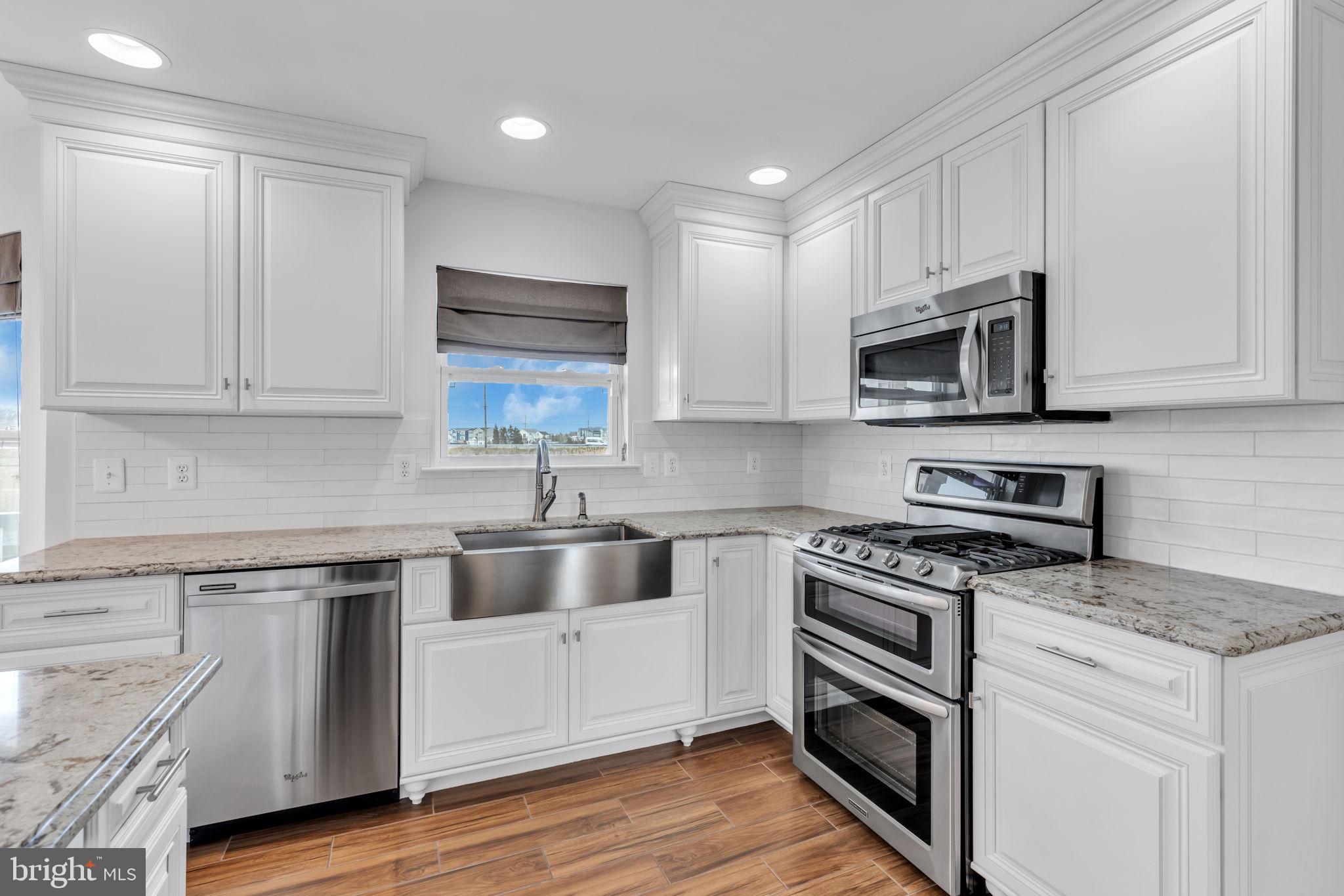 68 Morris Boulevard Manahawkin, NJ 08050 - Photo 13 of 43 a kitchen with cabinets stainless steel appliances and a sink