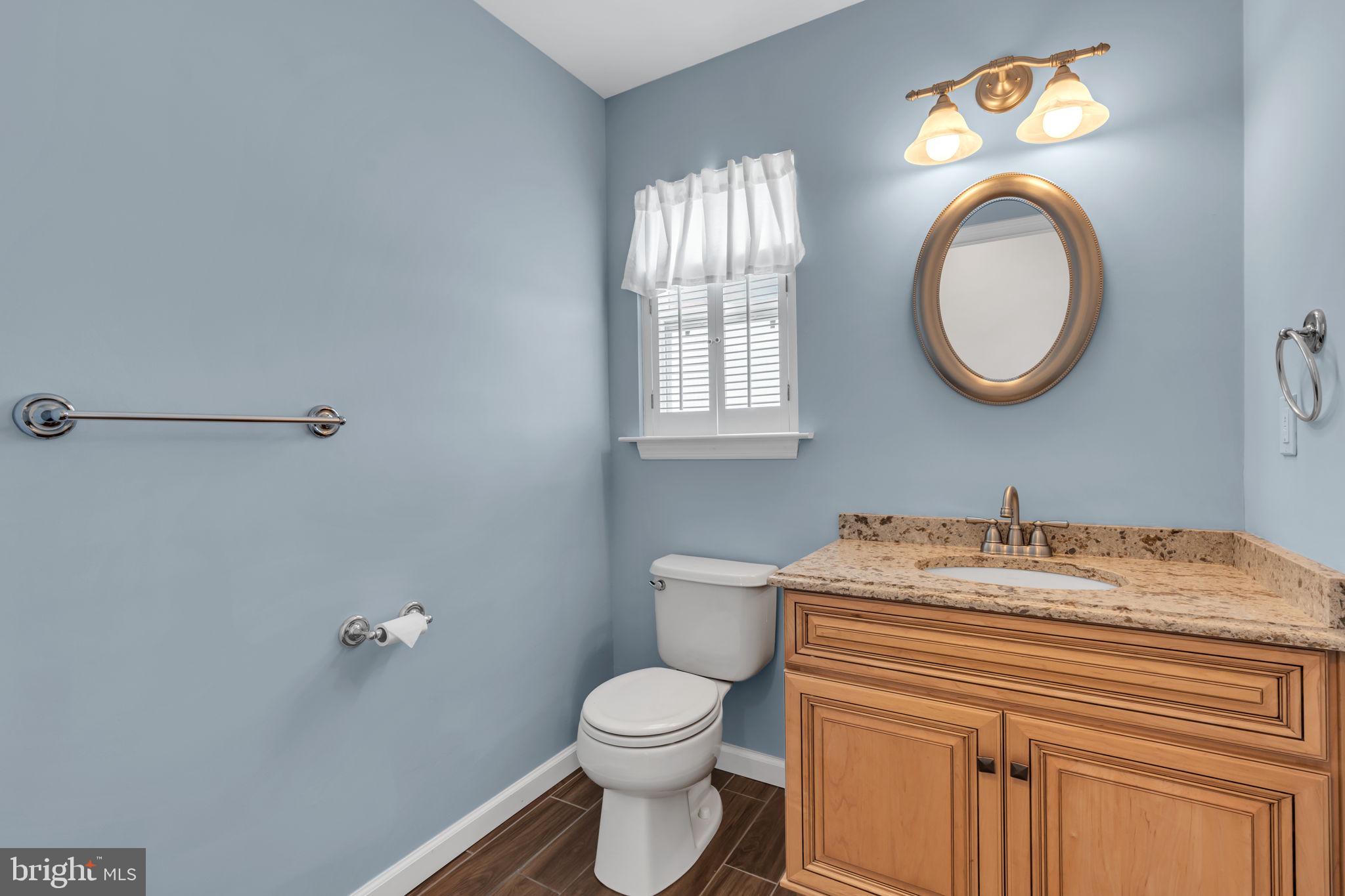 68 Morris Boulevard Manahawkin, NJ 08050 - Photo 19 of 43 a bathroom with a toilet sink vanity and mirror