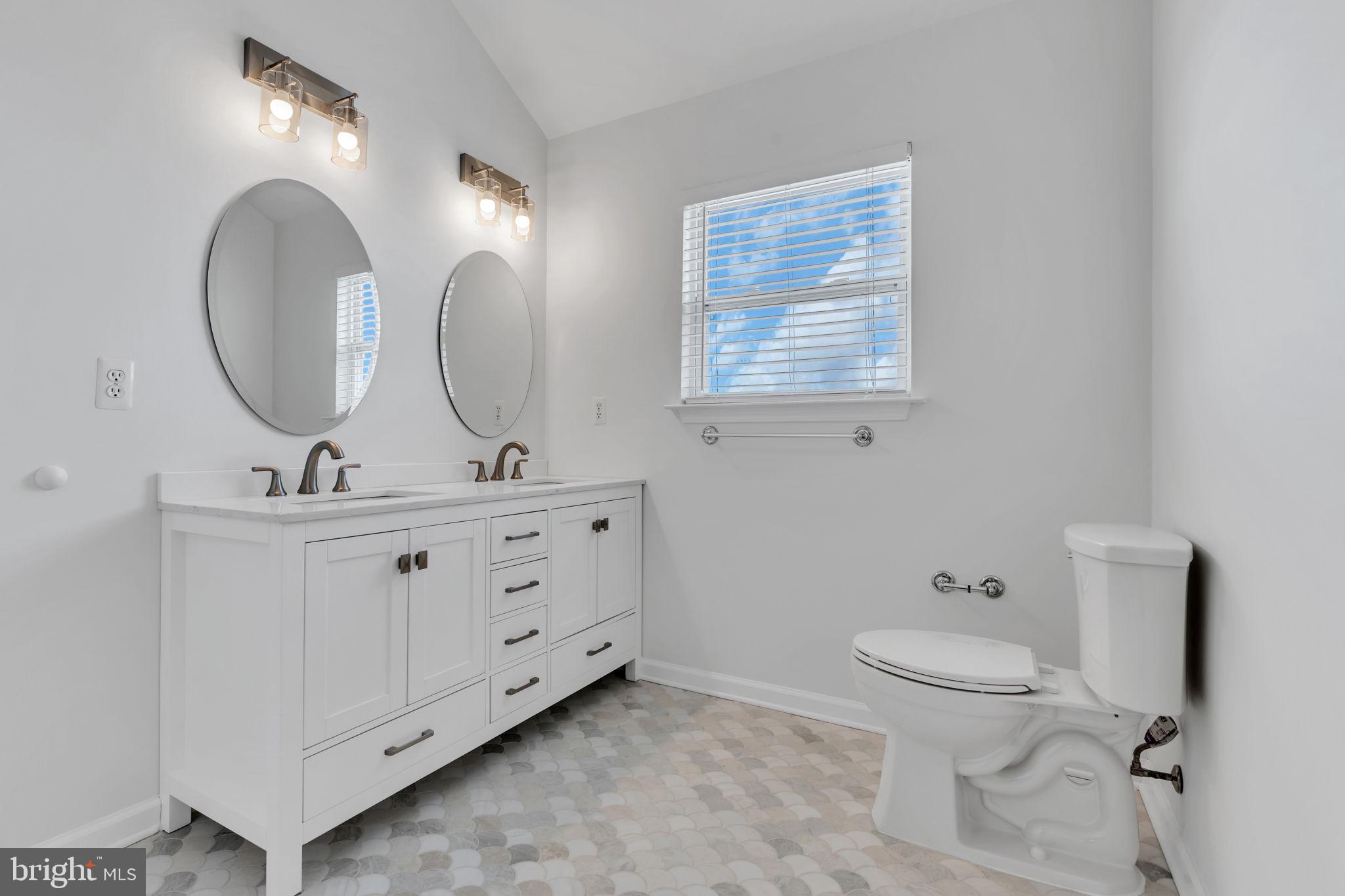 68 Morris Boulevard Manahawkin, NJ 08050 - Photo 30 of 43 a bathroom with 2 sink toilet and a mirror