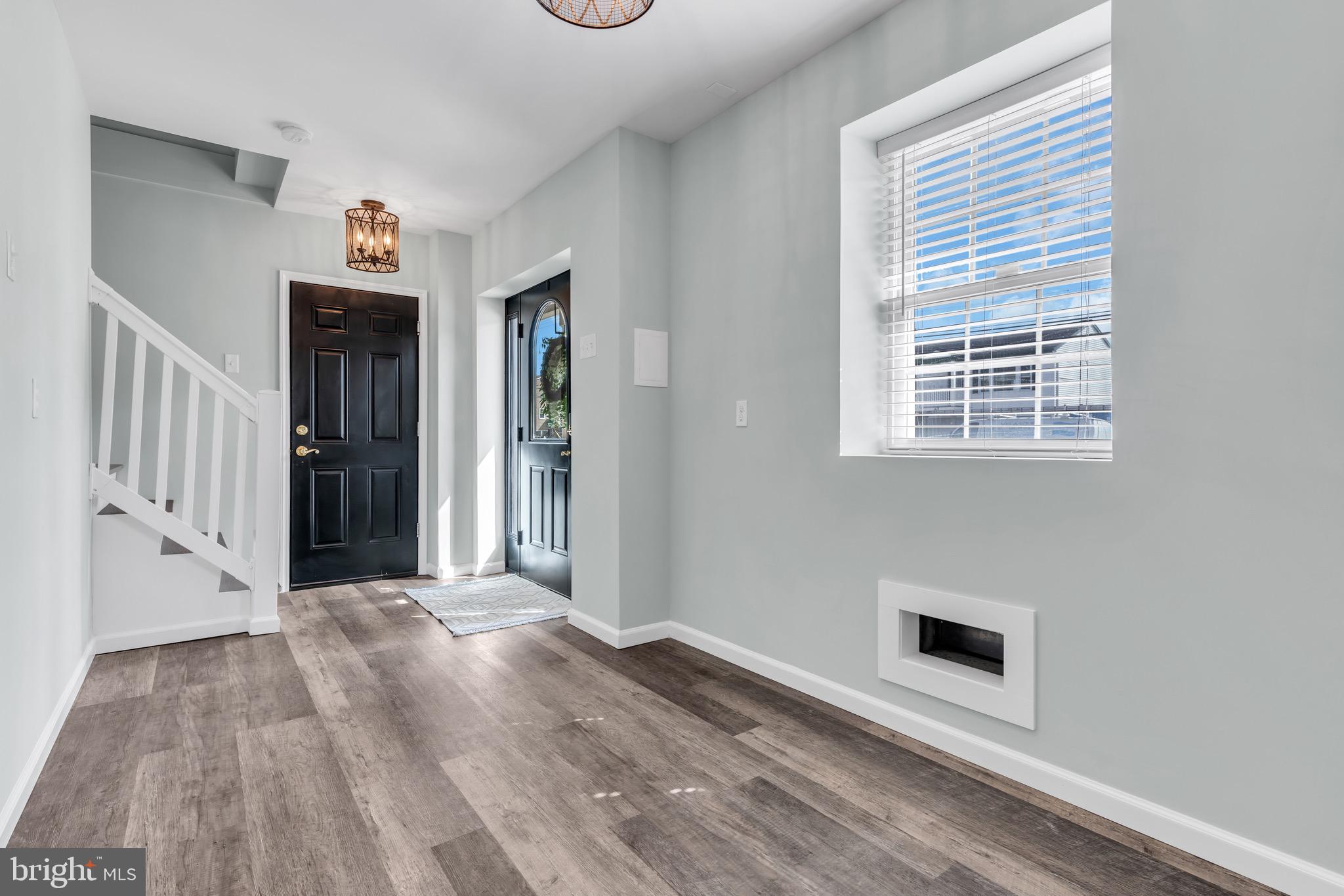 68 Morris Boulevard Manahawkin, NJ 08050 - Photo 3 of 43 a view of a hallway with wooden floor and a fireplace