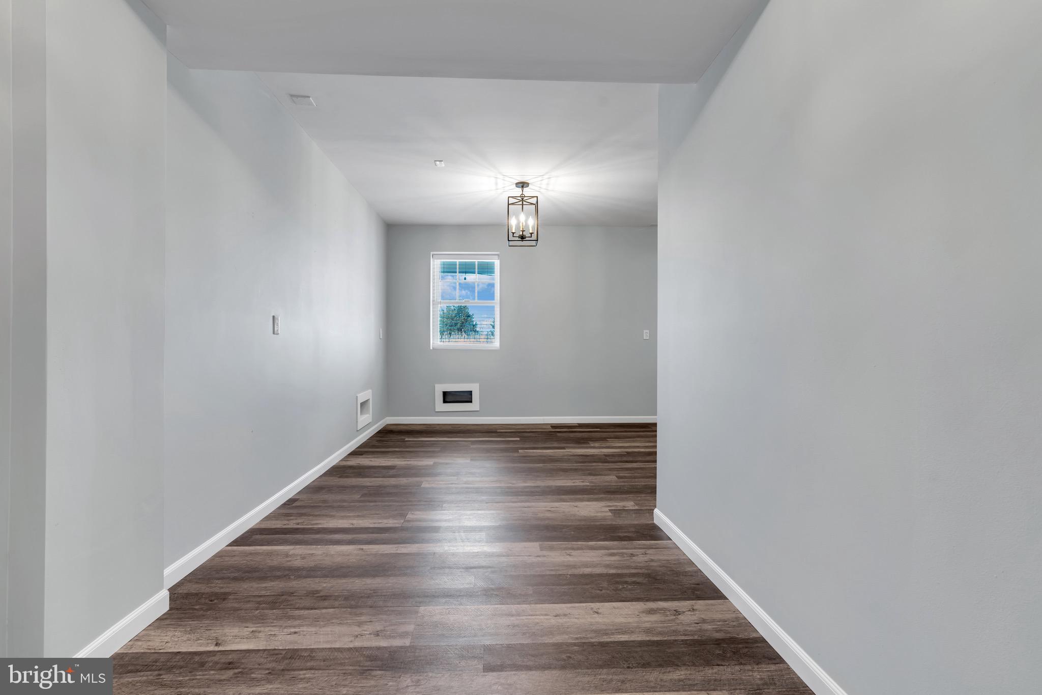 68 Morris Boulevard Manahawkin, NJ 08050 - Photo 4 of 43 a view of a hallway with wooden floor and chandelier