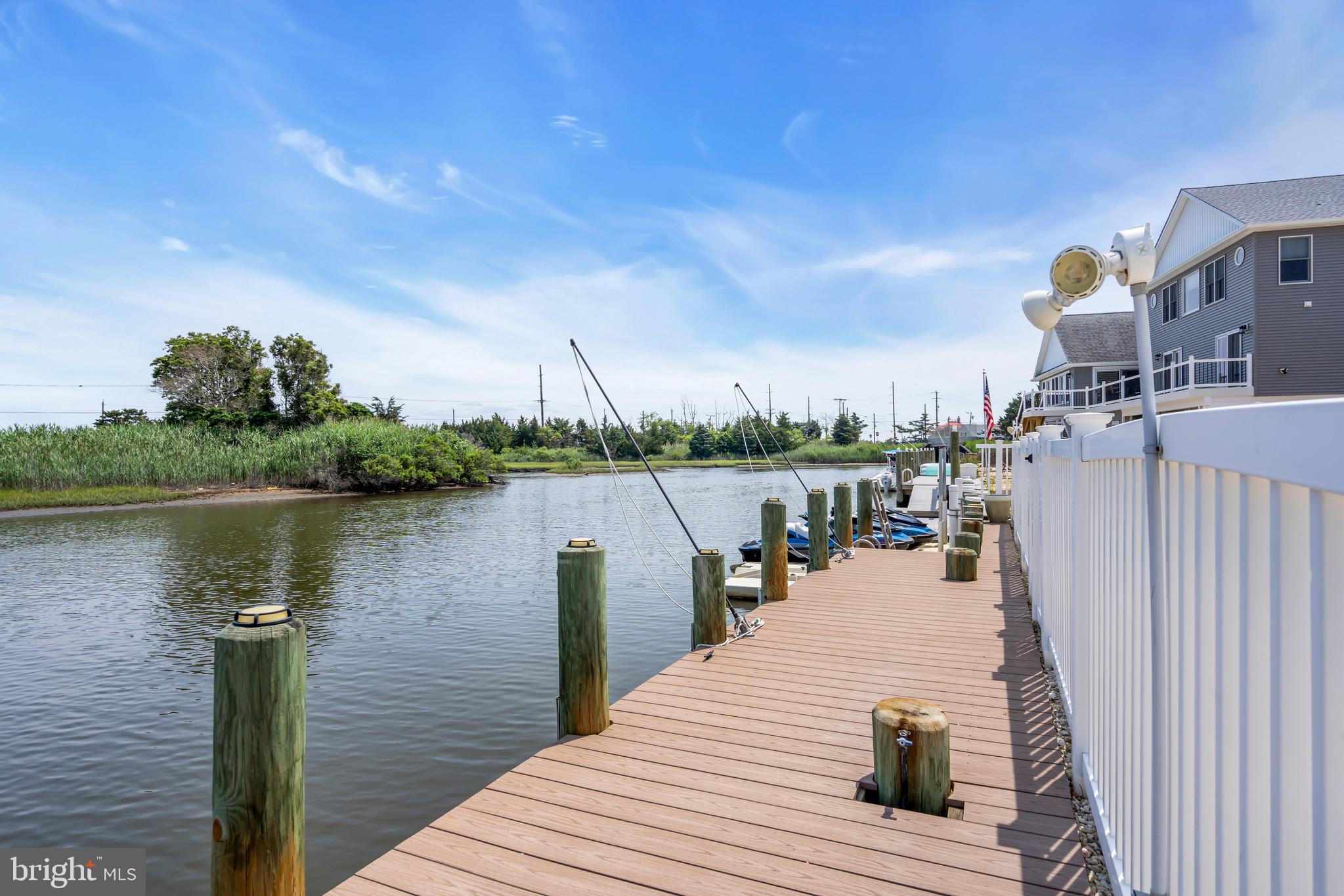 68 Morris Boulevard Manahawkin, NJ 08050 - Photo 42 of 43 a view of a lake with boats and trees in the background