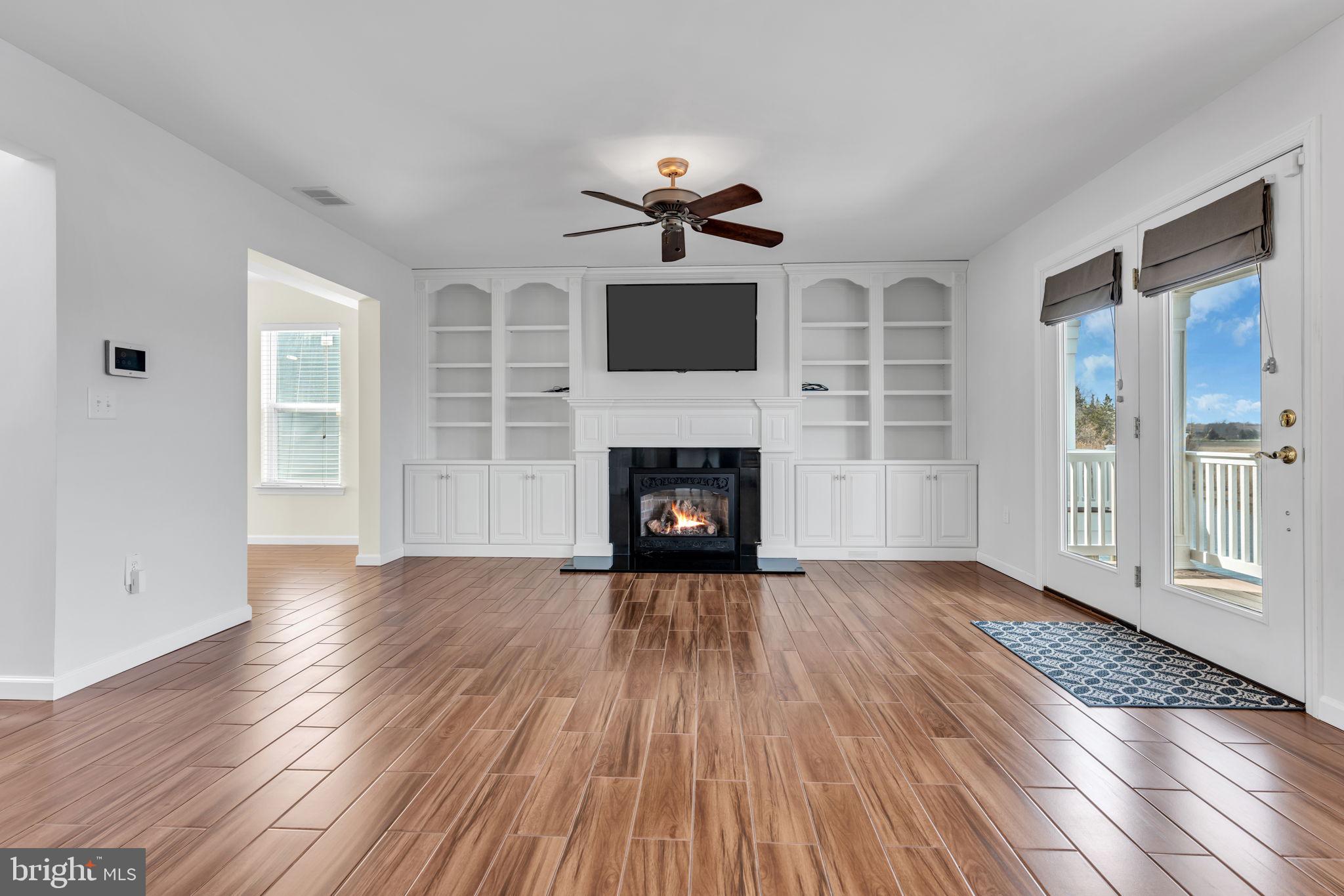 68 Morris Boulevard Manahawkin, NJ 08050 - Photo 9 of 43 a view of a livingroom with wooden floor fireplace and windows