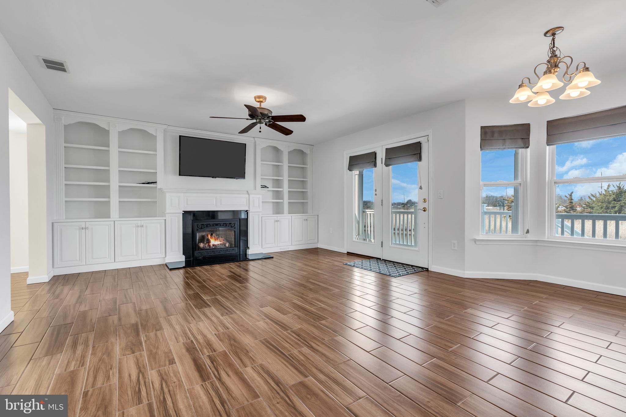 68 Morris Boulevard Manahawkin, NJ 08050 - Photo 10 of 43 a view of an empty room with wooden floor fireplace and a window