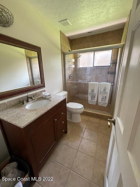 866 Spanish Wells Drive Melbourne, FL 32940 - Photo 11 of 18 a bathroom with a double vanity sink toilet and mirror