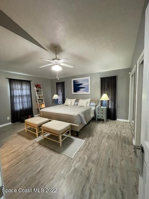 866 Spanish Wells Drive Melbourne, FL 32940 - Photo 13 of 18 a spacious bedroom with a bed mirror and window