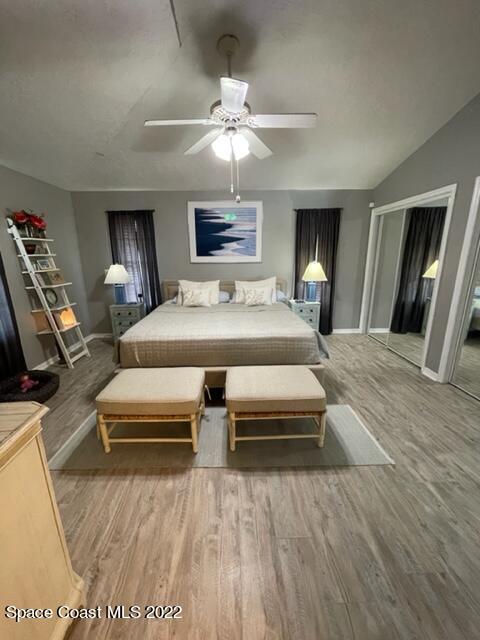 866 Spanish Wells Drive Melbourne, FL 32940 - Photo 14 of 18 a bedroom with a large bed a chandelier and dresser