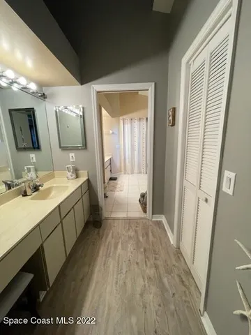 a bathroom with a sink mirror vanity and toilet