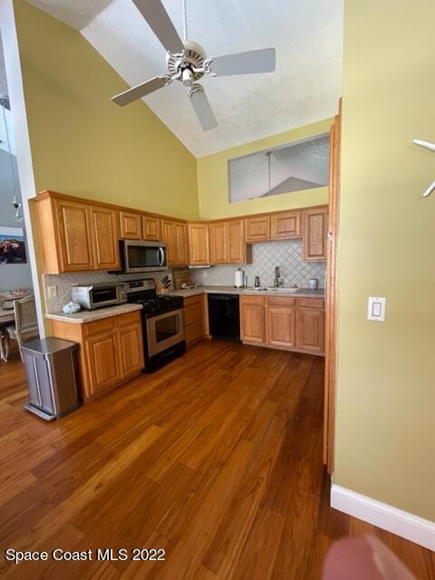 866 Spanish Wells Drive Melbourne, FL 32940 - Photo 6 of 18 a kitchen with stainless steel appliances a stove top oven a sink and a refrigerator