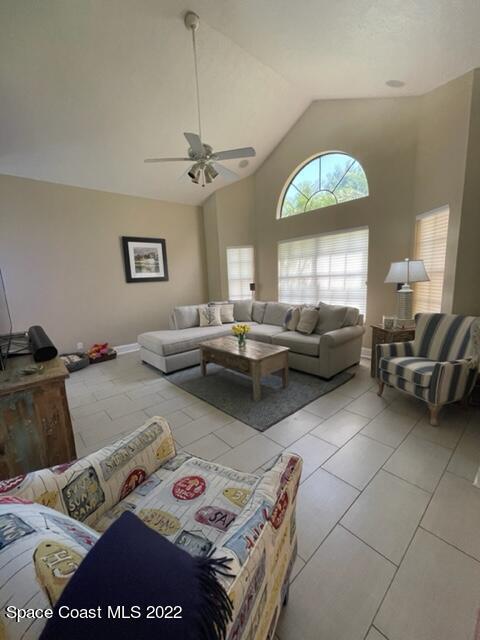 866 Spanish Wells Drive Melbourne, FL 32940 - Photo 9 of 18 a living room with furniture and a chandelier