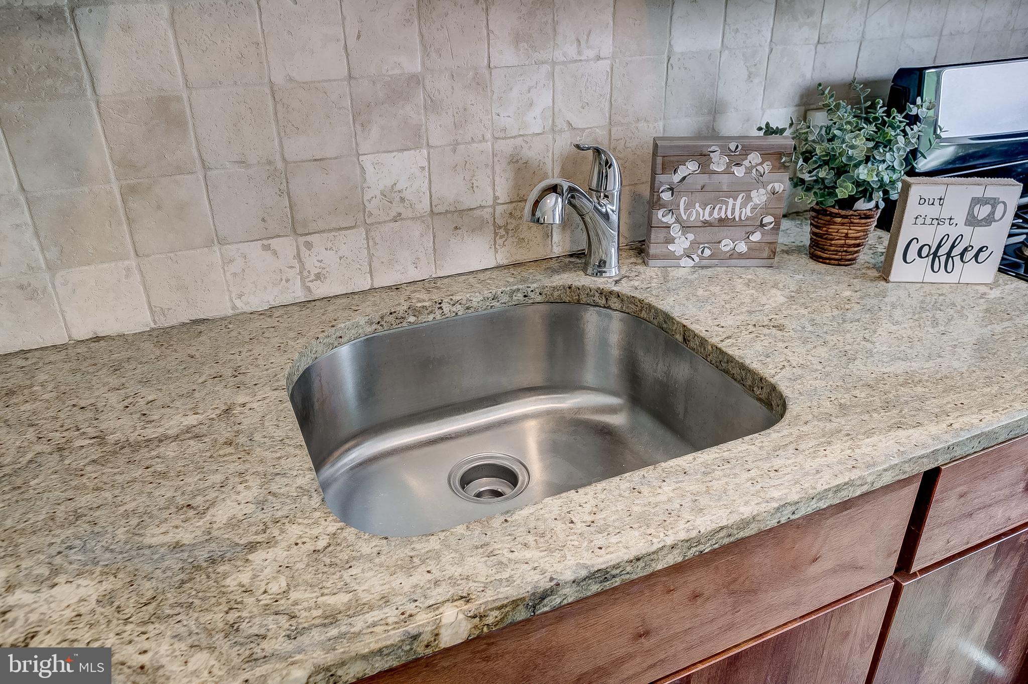 1306 Silverthorne Road Baltimore, MD 21239 - Photo 13 of 31 Tumble Stone Backsplash that Accents the Granite