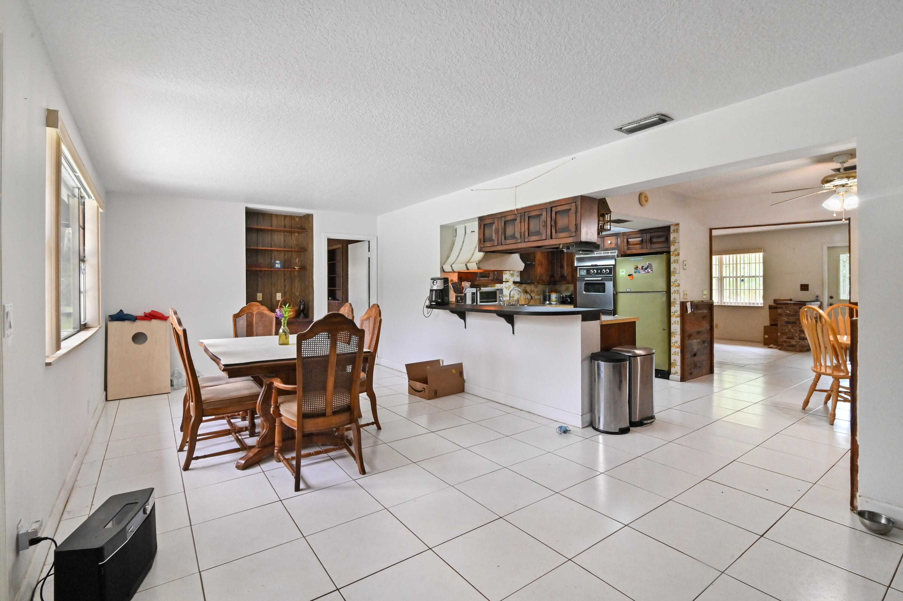 3208 A Road Loxahatchee Groves, FL 33470 - Photo 12 of 51 a workspace with furniture a window and a view of kitchen