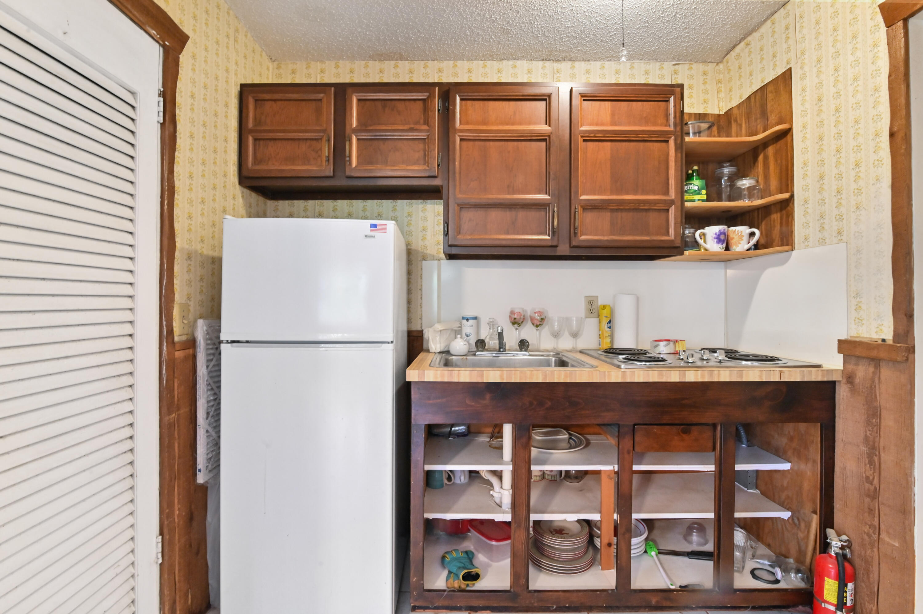3208 A Road Loxahatchee Groves, FL 33470 - Photo 15 of 51 a kitchen with a refrigerator and a window
