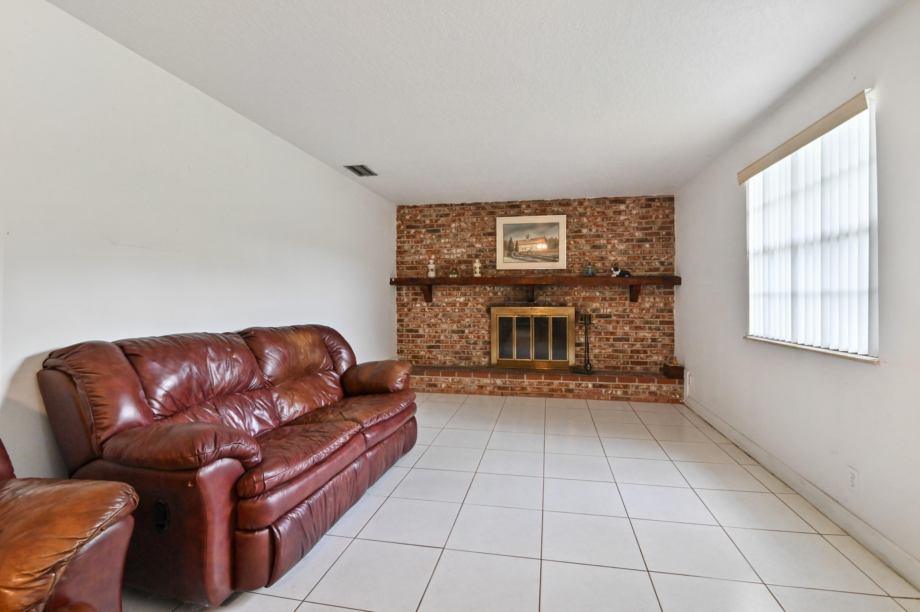 3208 A Road Loxahatchee Groves, FL 33470 - Photo 19 of 51 a living room with furniture and a fireplace