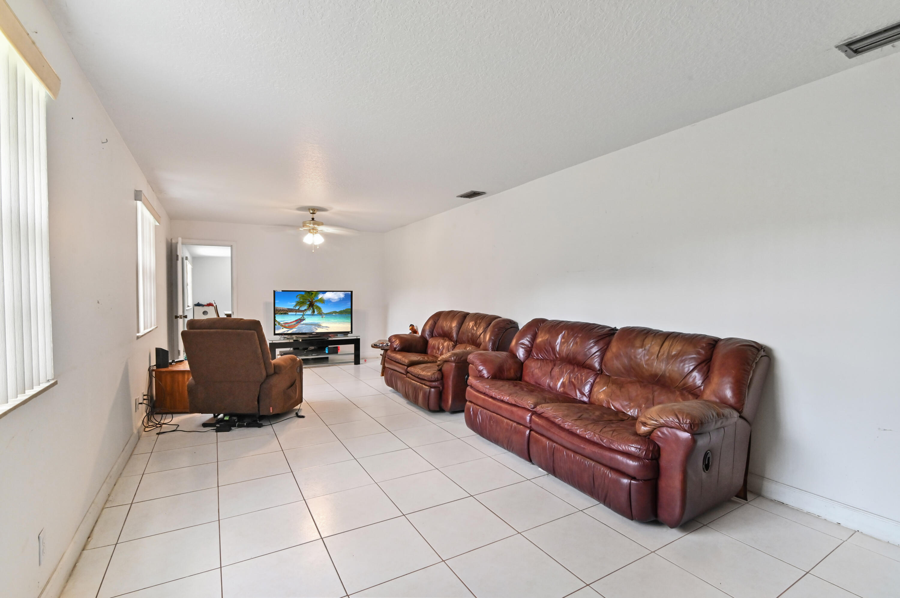 3208 A Road Loxahatchee Groves, FL 33470 - Photo 20 of 51 a living room with couches and furniture with kitchen view