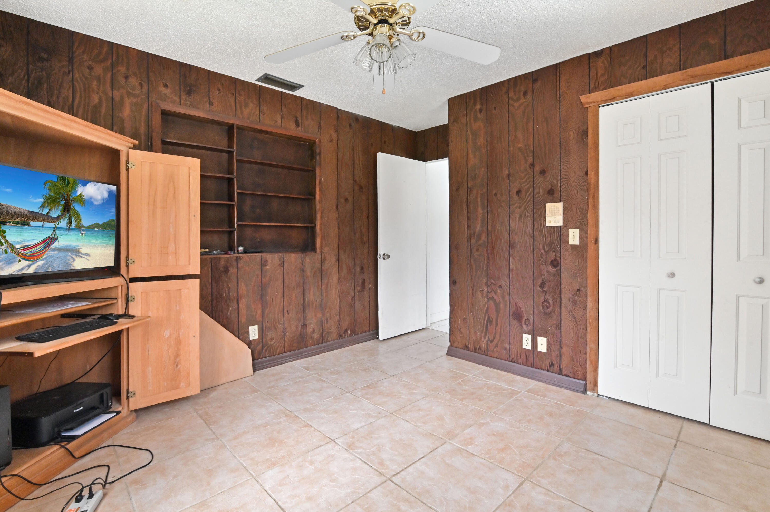 3208 A Road Loxahatchee Groves, FL 33470 - Photo 22 of 51 an empty room with ceiling fan and window