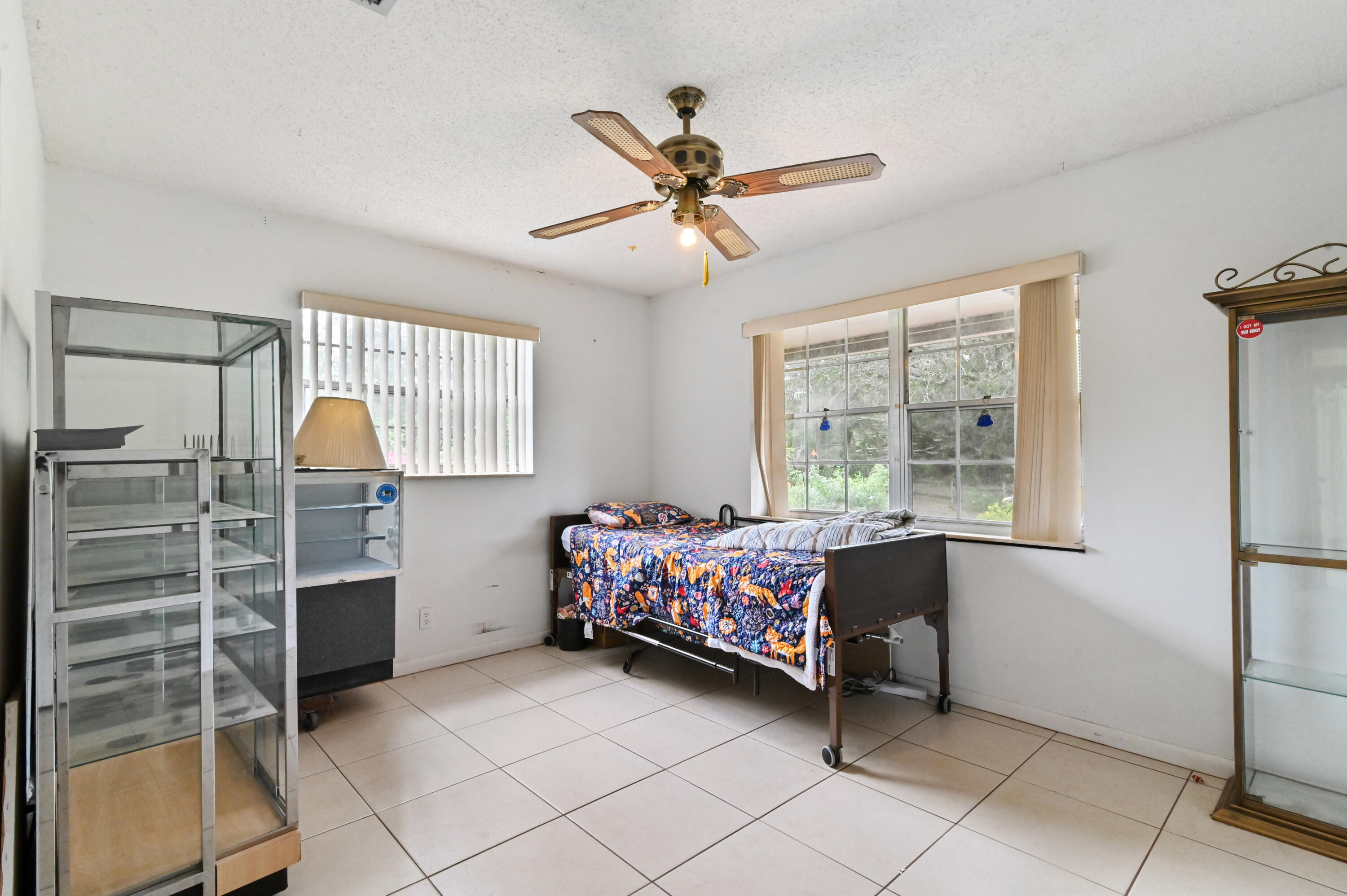 3208 A Road Loxahatchee Groves, FL 33470 - Photo 23 of 51 a bedroom with a bed and a window