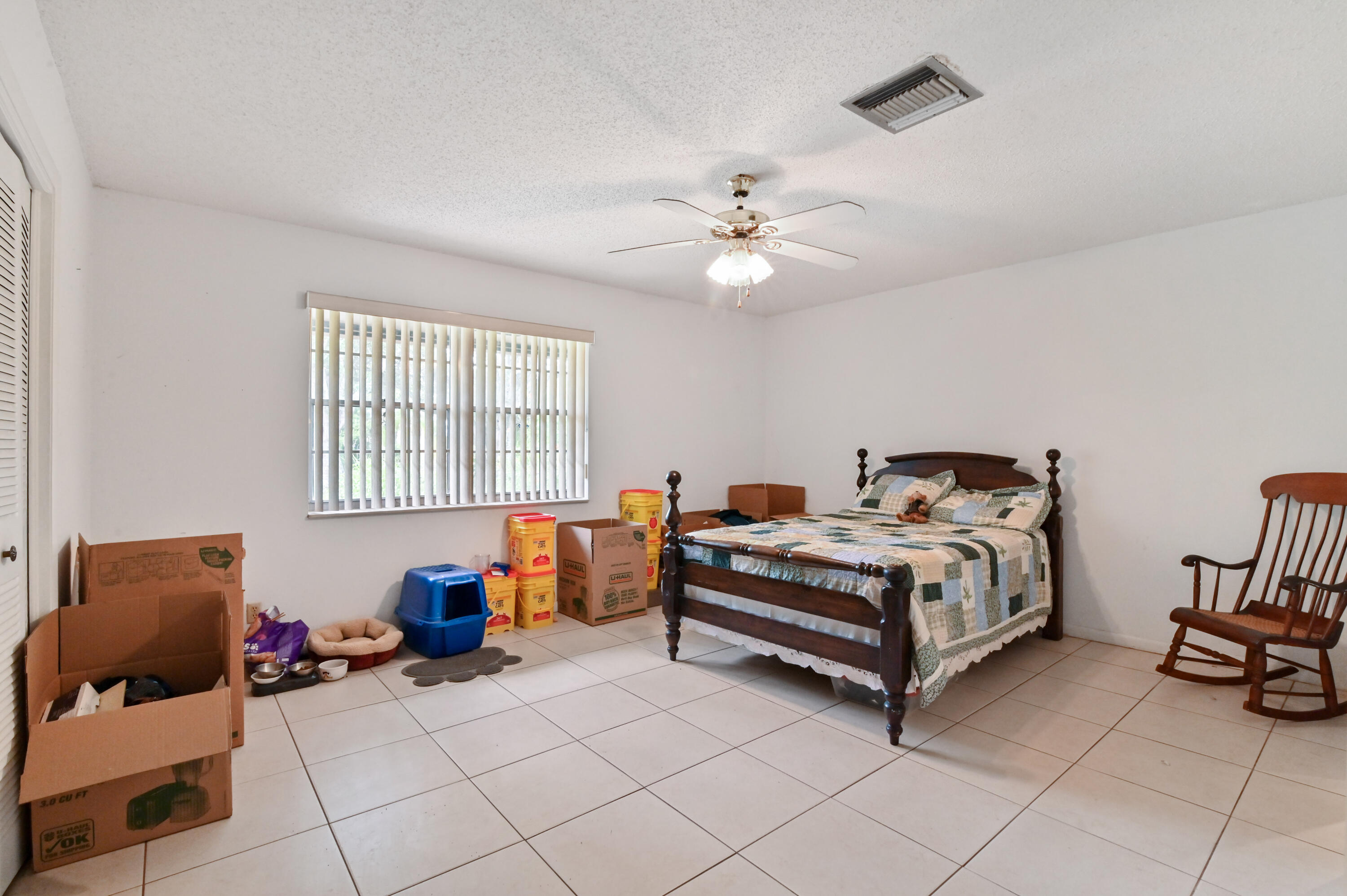 3208 A Road Loxahatchee Groves, FL 33470 - Photo 27 of 51 a bed room with a bed and a couch