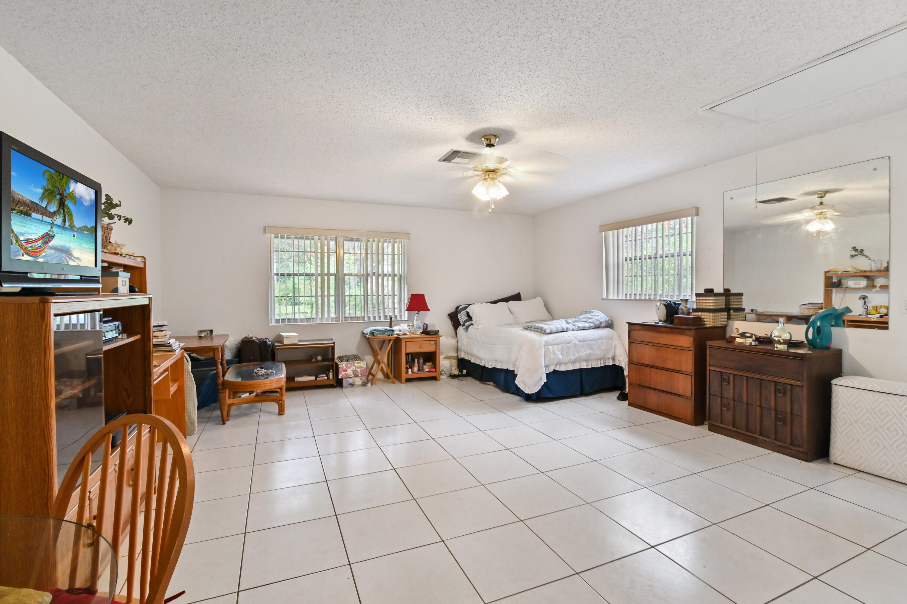 3208 A Road Loxahatchee Groves, FL 33470 - Photo 30 of 51 a living room with furniture and a flat screen tv